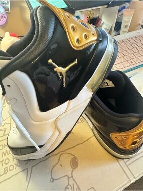 Jordan White and Black Retro Sneakers with Gold Accent